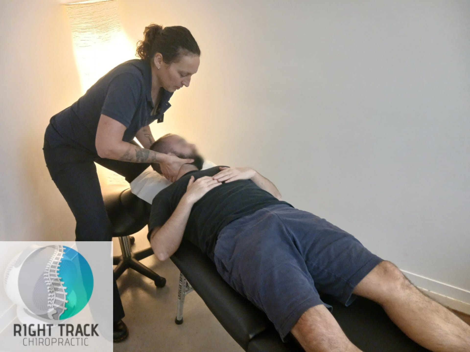 Chiropractor performing a spinal adjustment during a treatment session